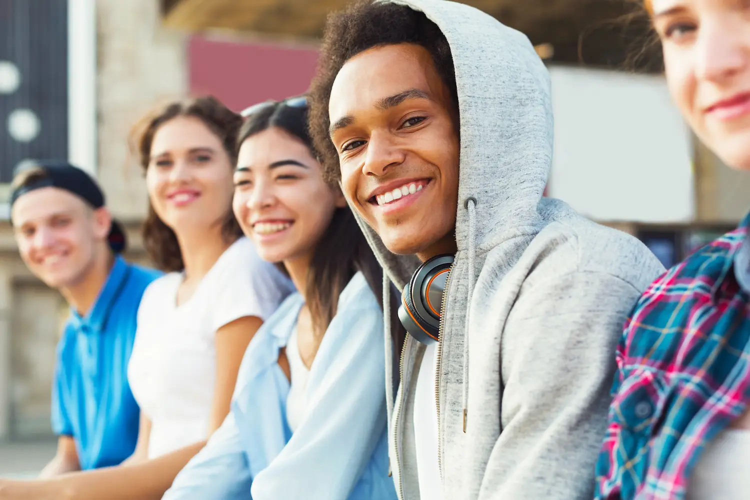 A diverse group of teenagers smiling at the camera